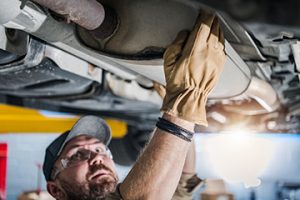 Closeup,Of,Car,Catalytic,Converter,Being,Checked,By,Professional,Mechanic - Meineke Alabama Meineke Car Care | Catalytic Converter | Madison AL
