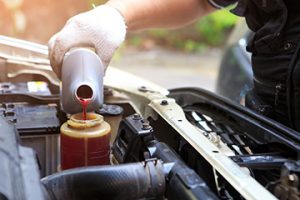 Male,Hand,Filling,Car,Power,Steering,Fluid - Meineke Alabama Meineke Car Care | Transmission Fluid | Bessemer AL